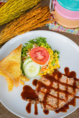 Beef steak with black pepper sauce , salad and French fries on s
