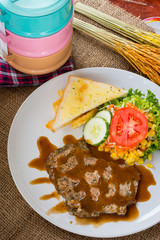 Beef steak with black pepper sauce , salad and French fries on s