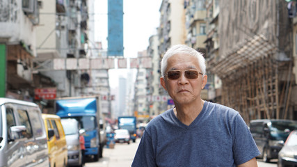 senior asian man with hong kong urban architecture scene