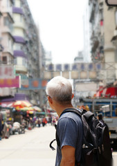 senior man with hong kong urban architecture scene