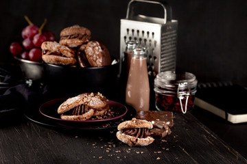 Christmas almond cookies and chocolate milkshake on dark wooden