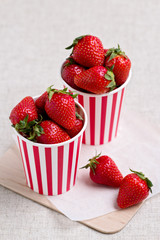 Strawberries in a striped cups. Selective focus.