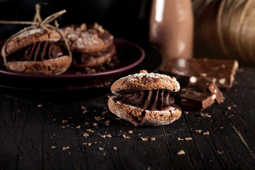 Christmas almond cookies with pieces of chocolate on old wooden