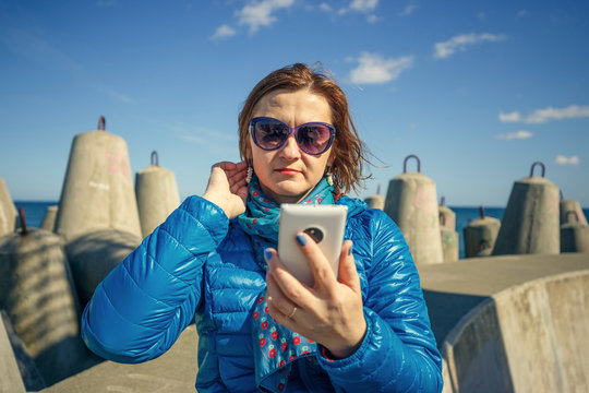 woman taking self-portrait on smartphone