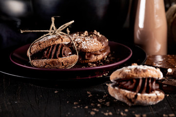 Maroni cookies with pieces of chocolate on old wooden background
