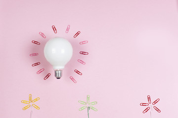 great idea concept with crumpled colorful paper and light bulb on light background. Creative brainstorm concept business idea.  female hand holding light bulb. Copy space for text.