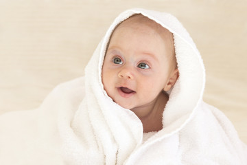 Adorable baby girl in a white towel