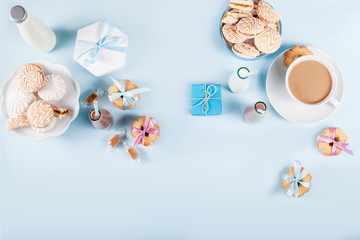 Baby shower with cookies and gifts on blue background