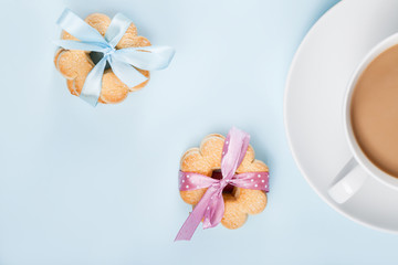 Fototapeta na wymiar Cookies with cup of coffee on blue, top view