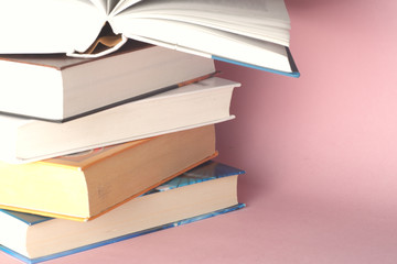 Stack of colorful books, grungy blue background, free copy space. Education essential for self improvement, gaining knowledge and success in our careers, business and personal lives.