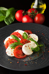 Caprese salad with mozzarella, fresh tomato and basil