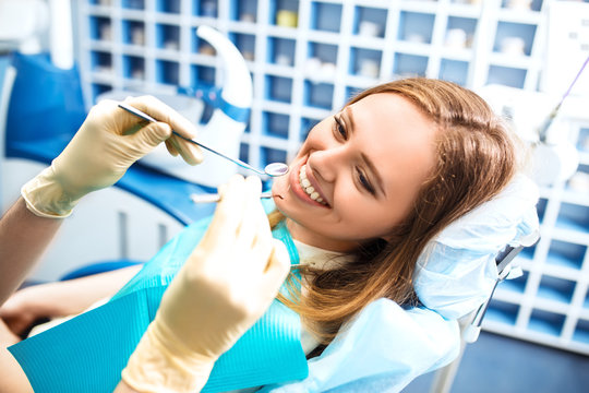 Overview of dental caries prevention.Woman at the dentist's chair during a dental procedure. Beautiful Woman smile close up. Healthy Smile. Beautiful Female Smile
