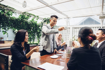 business Friends Cheering With Coffee at cafe