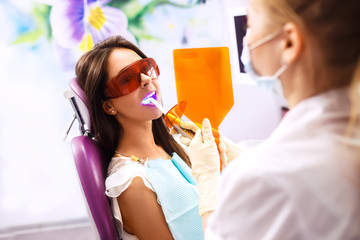 Overview of dental caries prevention.Woman at the dentist's chair during a dental procedure....