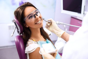 Overview of dental caries prevention.Woman at the dentist's chair during a dental procedure....