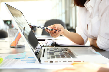 Business adviser analyzing financial figures denoting the progress in the work of company