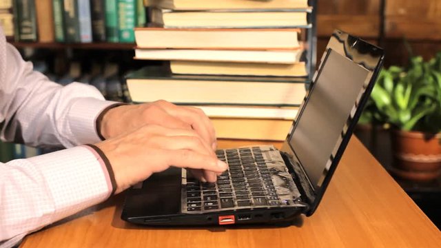 man was typing something into his laptop