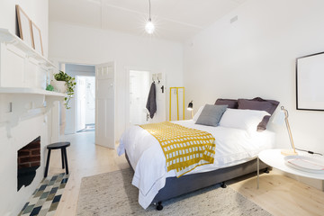 Stylish contemporary bedroom with ensuite and yellow accents