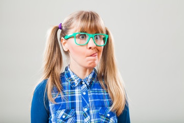 Studio shot portrait of nerdy woman who is making funny face