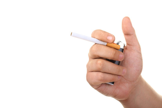 cigarette with orange filters on white isolated background in the hand of man with a lighter