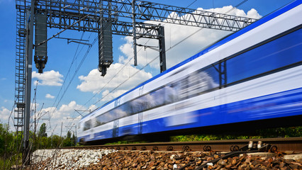 Modern electric passenger train moving on full speed