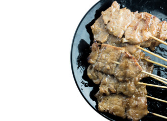 Grilled pork stick and black dish on white background