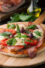 Fototapeta na wymiar Delicious pizza with bacon and mozzarella cheese