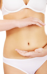 Slim woman belly with hand on it