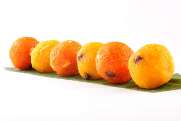  yellow and  Red Diwali sweets  Ladoo or bundi laddu in leaf.