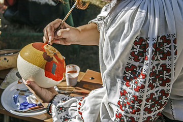 Woman painting ostrich egg