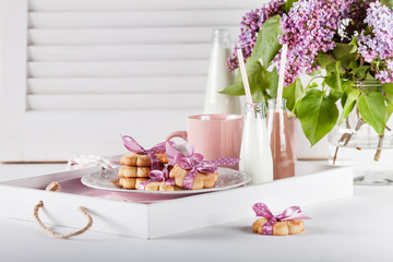 Fototapeta na wymiar Sweet surprise- cookies and mugs on a tray