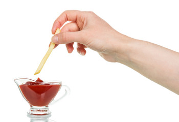 Female hand down french fries with ketchup in  cup isolated.