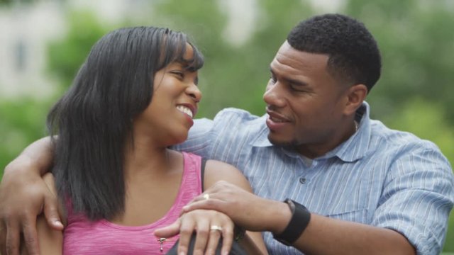  Portrait of happy African American couple relaxing in the park. 
