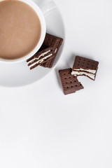 Cookies on white plate and cup of coffee