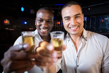 Handsome men drinking together