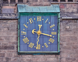 old clock with golden Roman numbers