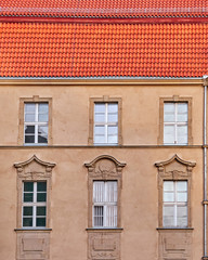 old elegant building facade and red tiles roof