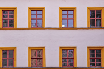 pale white building facade with orange framed windows