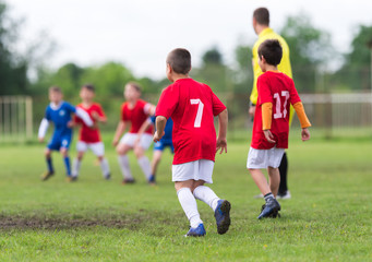 Obraz premium Boys kicking ball