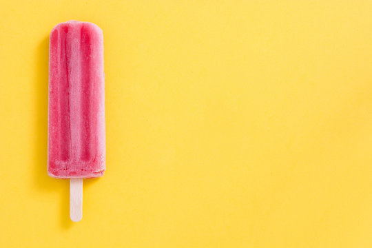 Strawberry Popsicle On Yellow Background
