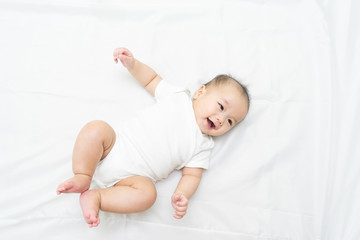Portrait of a newborn Asian baby on the bed