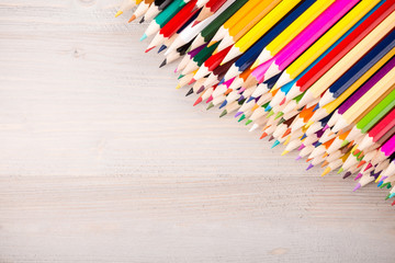 Color pencils pile on wooden background