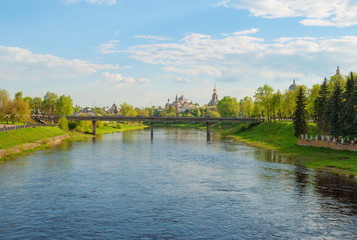 Fototapeta premium View of the River Tvertsa, bridge and monastery in the ancient Russian city of Torzhok