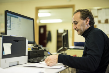 Office worker at desk working with documents