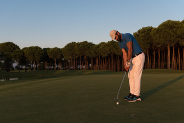 Fototapeta premium golfer hitting shot at golf course