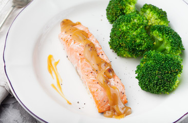 Salmon steak with creamy sauce and broccoli