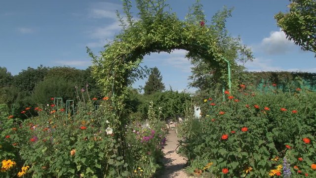Pretty pathway with arch through Monet&rsquo;s garden in Giverny, France