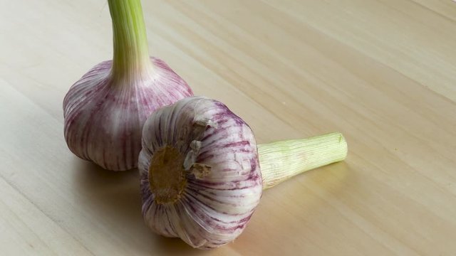 Garlic rotating on a wood background
