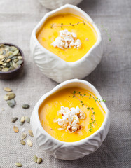 Pumpkin, corn soup with salty popcorn in a bowl 