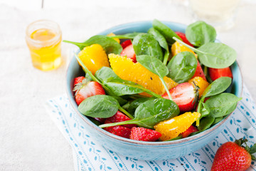 Fresh salad with strawberry, orange and spinach